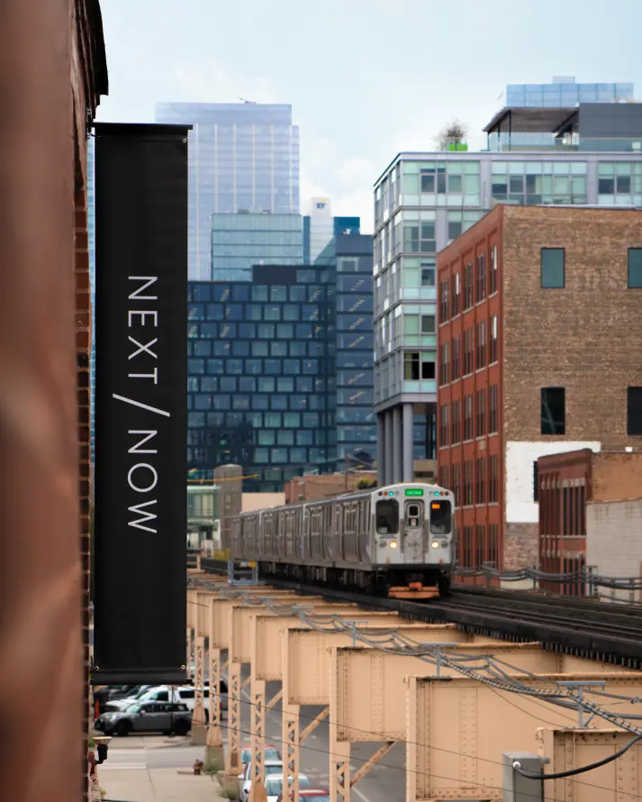 Chicago skyline, train in background, Next/Now banner in foreground